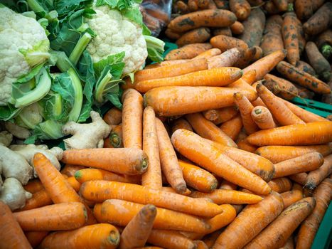 Cauliflower and carrots in the supermarket. Vegetables and fruits in a large assortment.