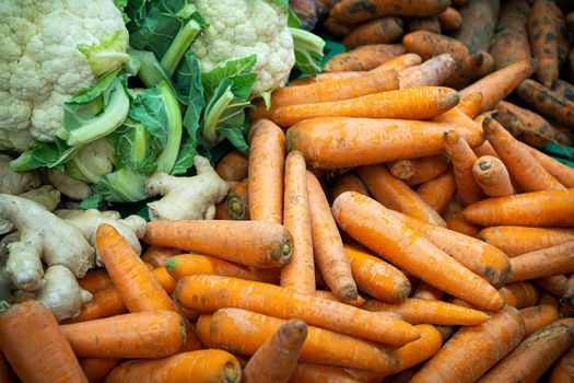 Cauliflower and carrots in the supermarket. Vegetables and fruits in a large assortment.