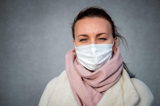 A picture of a girl in a mask. On the street. isolated Covid-19 pandemic.