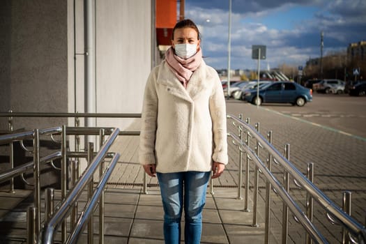 A picture of a girl in a mask. On the street. isolated Covid-19 pandemic.