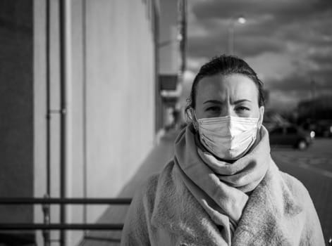 A picture of a girl in a mask. On the street. isolated Covid-19 pandemic.