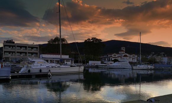 Beautiful view of boats in the harbour of Platamonas at sunset in Greece