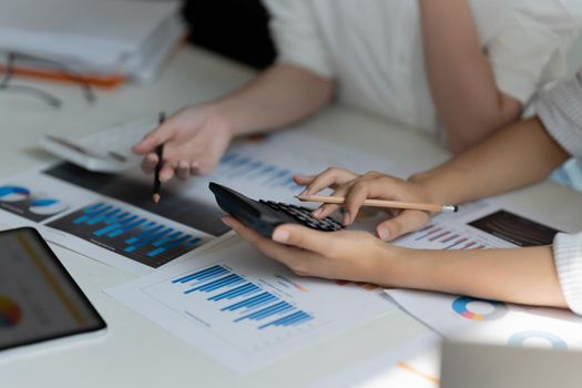 Close up accountant bookkeeper woman working about financial with calculator at his office to calculate expenses, Accounting concept.