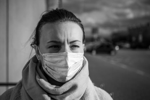 A picture of a girl in a mask. On the street. isolated Covid-19 pandemic.