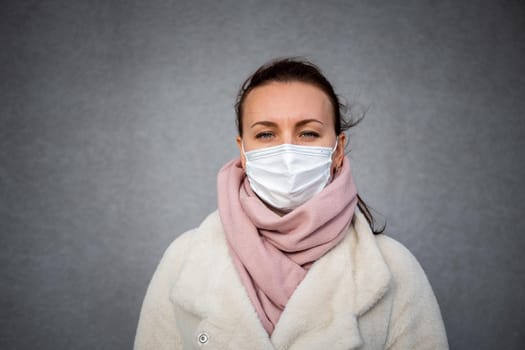 A picture of a girl in a mask. On the street. isolated Covid-19 pandemic.