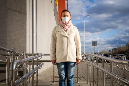 A picture of a girl in a mask. On the street. isolated Covid-19 pandemic.