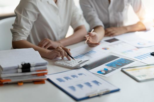 Close up accountant bookkeeper woman working about financial with calculator at his office to calculate expenses, Accounting concept.