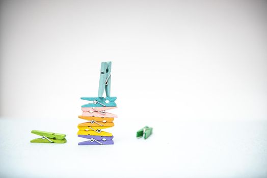 multi-colored clothespins for laundry on a white background.