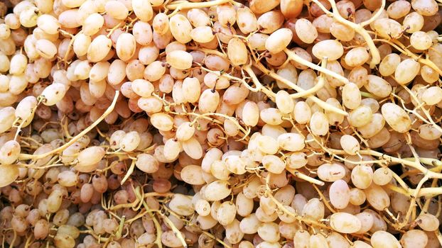 Sultana white seedless grapes on the market as background