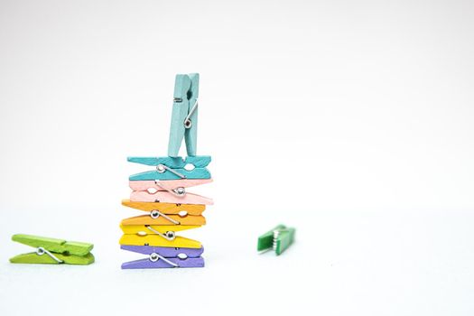 multi-colored clothespins for laundry on a white background.