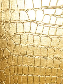 leather of crocodile texture golden color for natural yellow background close-up
