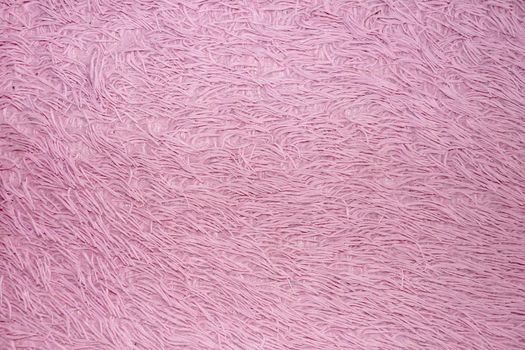 pink faux fur for textile fur background close-up.
