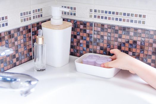 Washing hands with kid soap under the faucet with water. clean and Hygiene concept. Close up hands of kid