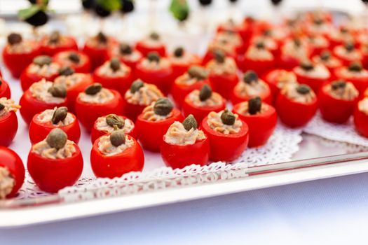 Close up of appetizers with stuffed Pachino tomatoes tuna sauce and capers for the party