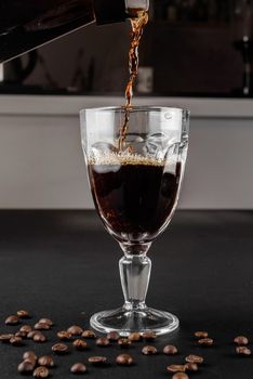 Alternative method of making coffee. coffeemaker is a manual pour-over style glass. Cofee brewing on black background