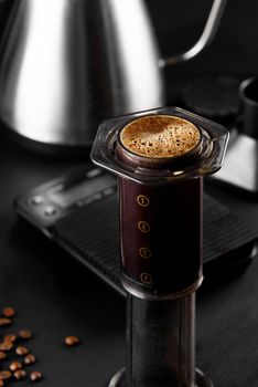 AeroPress on black background .The AeroPress is a device for brewing coffee. Coffee brewing.