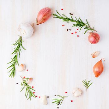 Round frame with seasonings. Ring food background with spices, rosemary with salt and pepper on white cream marble table, copy space, flat lay, top view