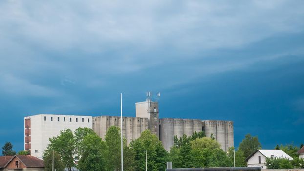 The concrete granary building in Križevci, Croatia. Under the blue sky.