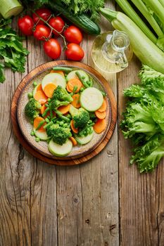 Mix of boiled vegetables, steam vegetables for dietary low-calorie diet. Vertical. Broccoli, carrots, cauliflower, top view.