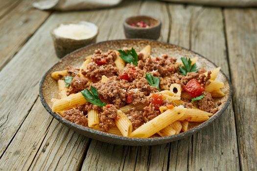 Bolognese pasta. Fusilli with tomato sauce, ground minced beef. Traditional italian cuisine. Side view.