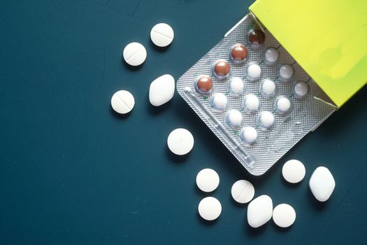 birth control pills on dark background, close up .