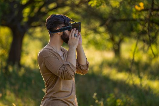 man wearing virtual reality glasses outdoors