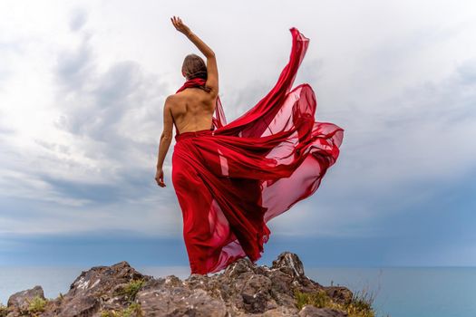 Woman in red dress dance over storm sky, gown fluttering fabric flying as splash.