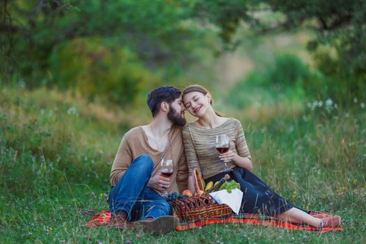 couple drinking wine from glasses in nature