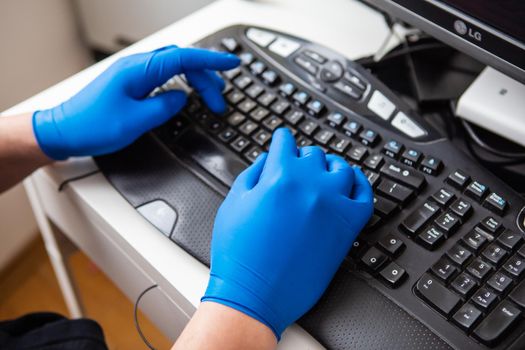 A doctor in blue gloves quickly collects data about a patient. The concept of healthcare and taking care of your health