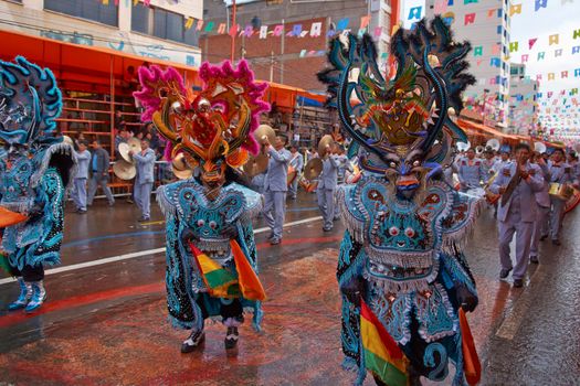 ORURO, BOLIVIA - FEBRUARY 25, 2017: Diablada dancers in ornate costumes parade through the mining city of Oruro on the Altiplano of Bolivia during the annual carnival.