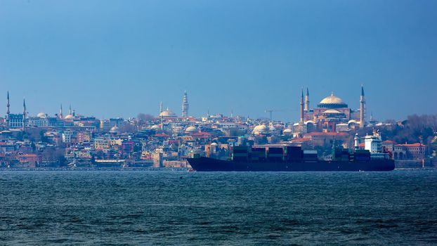 Container ship in Bosphorus with Old City in Background Hagia Sophia. Istanbul, Turkey