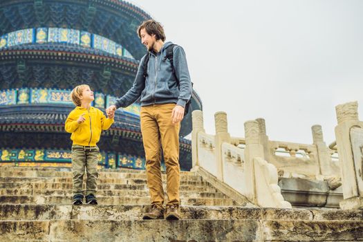 Dad and son travelers in the Temple of Heaven in Beijing. One of the main attractions of Beijing. Traveling with family and kids in China concept.