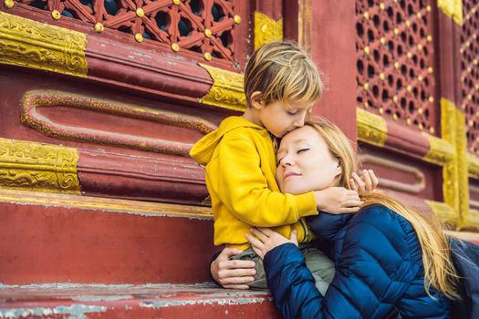 Mom and son travelers in the Temple of Heaven in Beijing. One of the main attractions of Beijing. Traveling with family and kids in China concept.