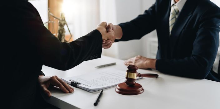 Businessman shaking hands to seal a deal Judges male lawyers Consultation legal services Consulting in regard to the various to plan the case.