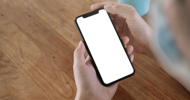 Top view Woman sitting and holding blank screen mock up mobile phone.
