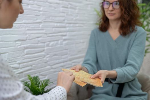 Psychologist uses metaphorical associative cards in a session with a patient