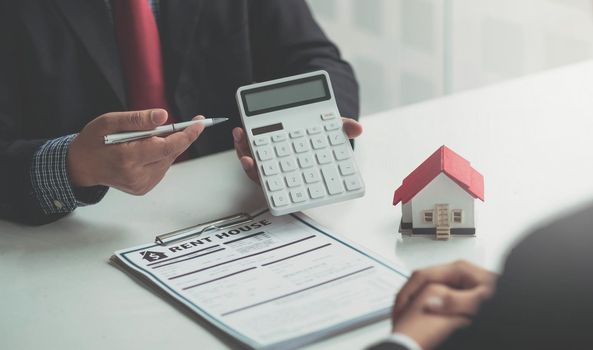 Real estate agent talked about the terms of the home purchase agreement and asked the customer to sign the documents to make the contract legally, Home sales and home insurance concept..