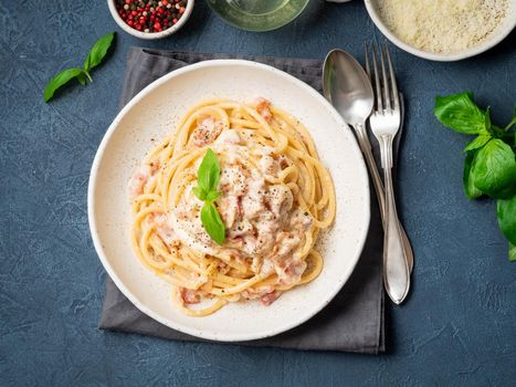 Carbonara pasta. Spaghetti with pancetta, egg, parmesan cheese and cream sauce. Traditional italian cuisine. Top view.
