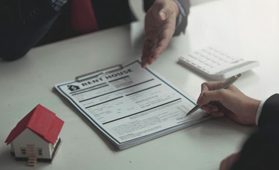 Salesmen are letting the male customers sign the sales contract, Asian women and men are doing business in the office, Business concept and contract signing.