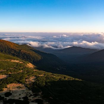 Photo of the Carpathians from a bird's eye view, drone flight over the mountains, clouds in the mountains.