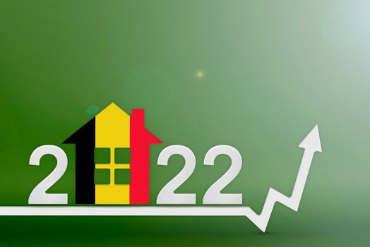 The cost of real estate in Belgium in 2022. Rising cost of construction, insurance, rent in Belgium. House model painted in the colors of the flag, up arrow on a green background.