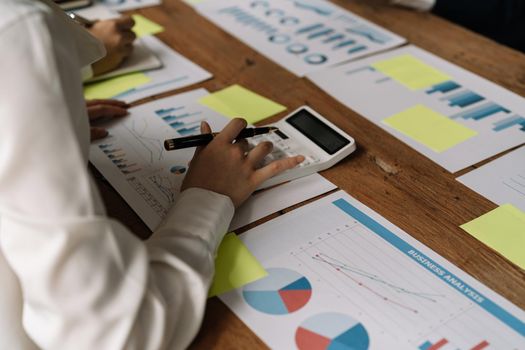 Business people discuss investment project working and planning strategy and using calculator during a business meeting.