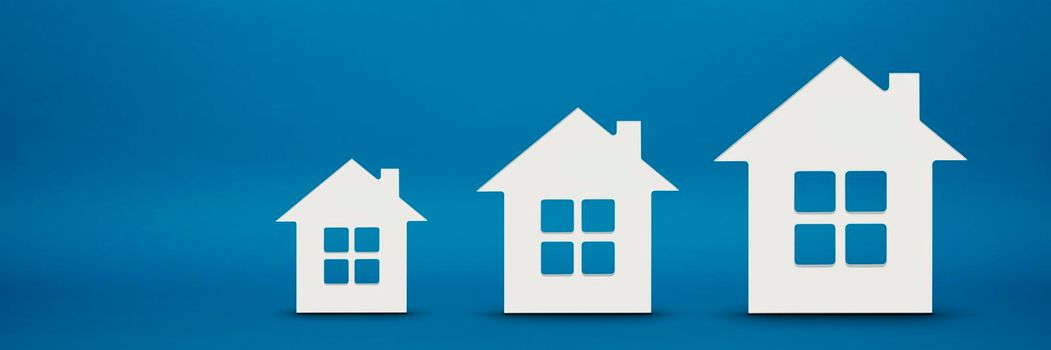 House model on a blue background. The concept of insurance or buying real estate on credit. Choosing a house or renting an apartment.
