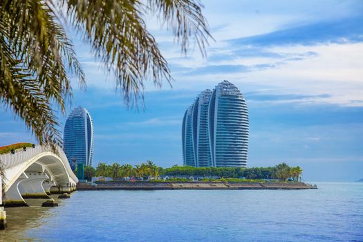 Travel tropical coastline lanscape with sea, foliage and palm leaves