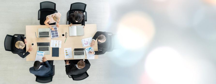 Business people group meeting shot from top widen view in office . Profession businesswomen, businessmen and office workers working in team conference with project planning document on meeting table .