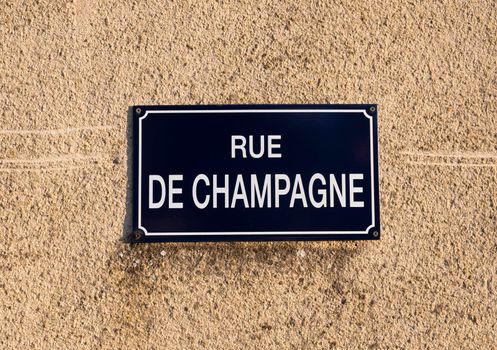 french street sign in region of champagne indicates rue champagne