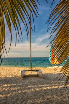 Colorful sail catamarans on the beach. The tropical resort area with the most beautiful beaches. 