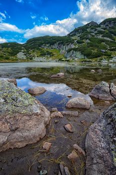 Beautiful landscape of mountain lake with algae in Rila mountain, Bulgaria. Vertical view