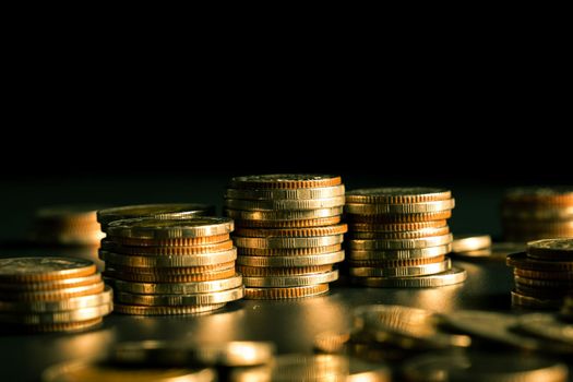 Pile of gold coins stack in finance treasury deposit bank account for saving . Concept of corporate business economy and financial growth by investment in valuable asset to gain cash revenue profit .