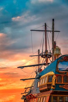 A part of the old colorful ship at sunset. Vertical view